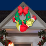 Load image into Gallery viewer, Gemmy Christmas Airblown Inflatable Grinch Hanging from Wreath Dr. Seuss, 4 ft Tall, Green
